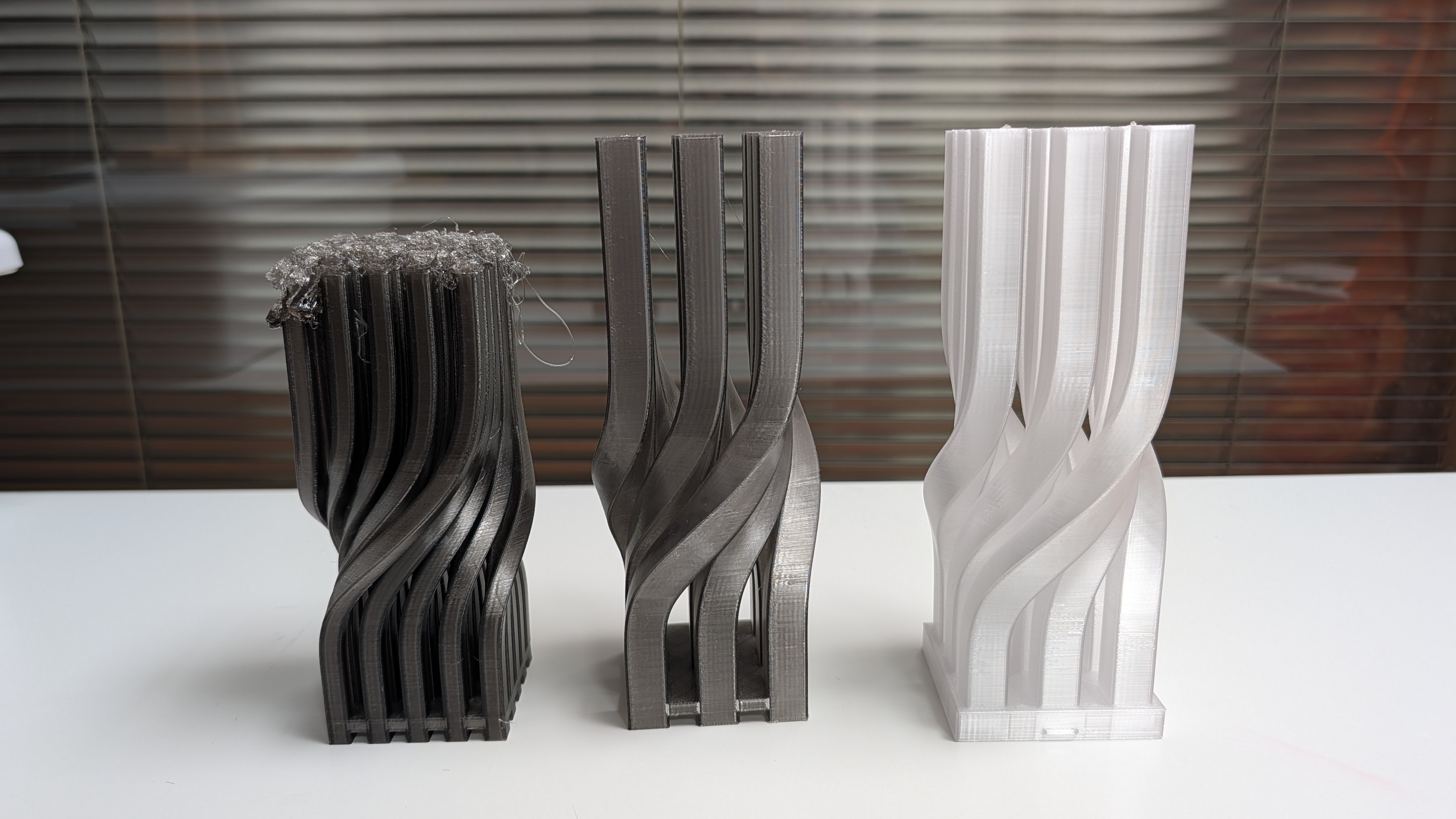 Iterations of the lamp design: failed print on left, 9-column version in middle, and final version on right
